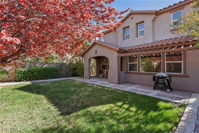Rear view of property featuring a covered patio an