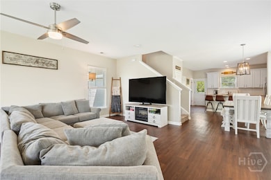 Living room opens to the dining room and kitchen.