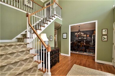 Two story foyer with hardwood floors flanked betwe