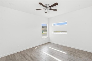 Empty room featuring light hardwood / wood-style floors and ceiling fan