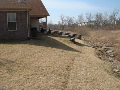 Covered back porch overlooks protected a