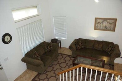Living room looking down from stairs flows into di