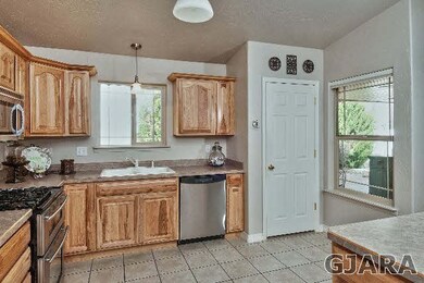 The kitchen features a pantry, as well as stainles