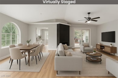 Living room with light wood-type flooring, a ceili