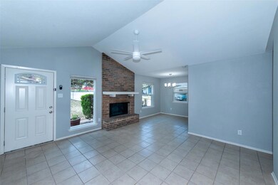 Unfurnished living room featuring a ceiling fan, 
