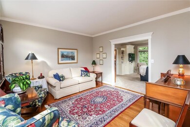 Living room with hardwood floors, plantation shutters