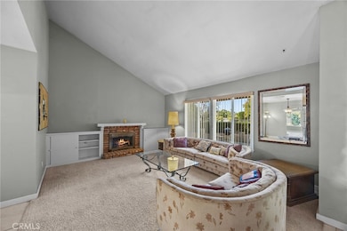 Spacious living room with brick fireplace and built-in bookcases