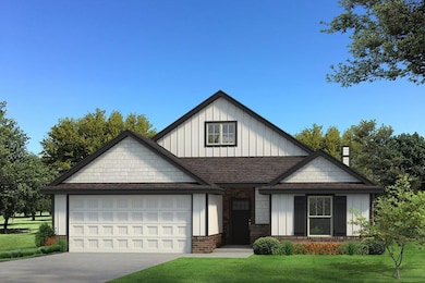 View of front facade featuring board and batten siding, a front lawn, concrete driveway, a garage, and brick siding