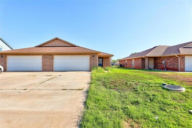 Single story home featuring a front yard and a gar