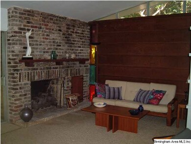 Den with fireplace and open to kitchen and dining 