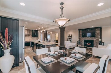This shows the open concept, additional dining space, & the cozy living room! 