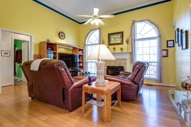Living room features fireplace and 12' ceilings