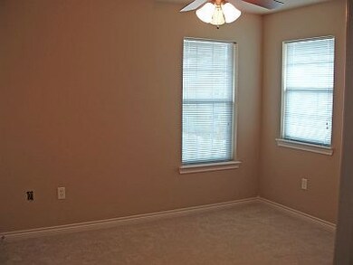 Empty room with carpet flooring and ceiling fan