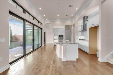 Kitchen has extended Island walls sliding glass do