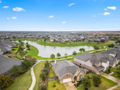 Stunning aerial view highlighting this homes spacious lake lot with no back neighbors.