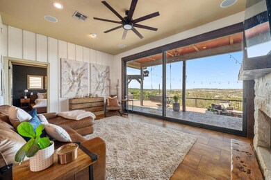 Tiled living area with ceiling fan, recessed ligh
