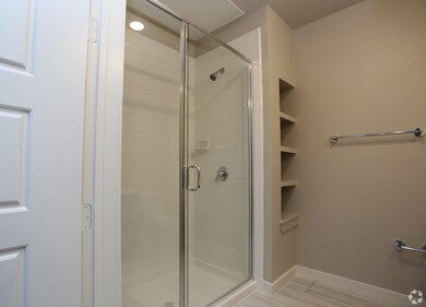 Bathroom with a shower with door and wood-type flooring