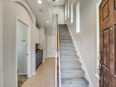 Stairway featuring light tile floors