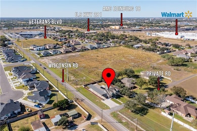 Aerial view of property and surrounding area featuring nearby suburban area