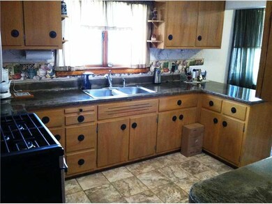 Kitchen. Finished concrete counter tops, gas range