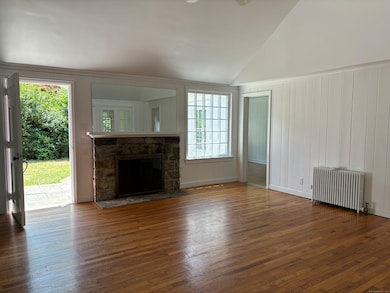 Wood burning fireplace in the living room with bedrooms on either side of the room