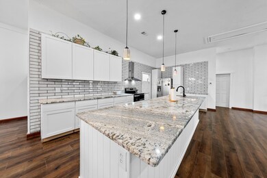 Kitchen featuring wall chimney range hood, stainle