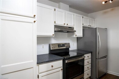 Entering kitchen area. Freshly painted throughout unit!