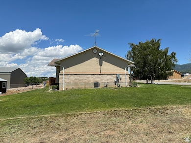 South Side View of property exterior featuring brick siding and stucco siding