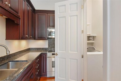 The open doors shows the laundry room with both wa