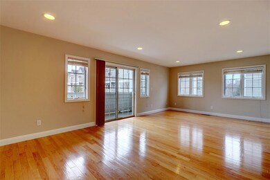  Living Room with Shiny Hardwoods and Private Balc