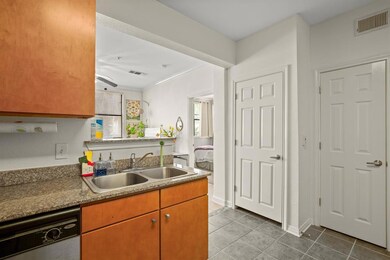 Kitchen featuring dishwasher, tile patterned floo