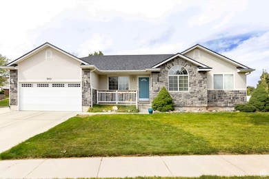 Ranch-style house with covered porch, stone siding, stucco siding, a front yard, and driveway