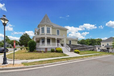 Victorian house featuring a porch and a front yard