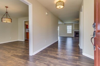 Nice and wide foyer with new flooring, paint and light fixtures.