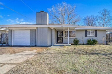 Ranch-style house featuring a front yard and a gar
