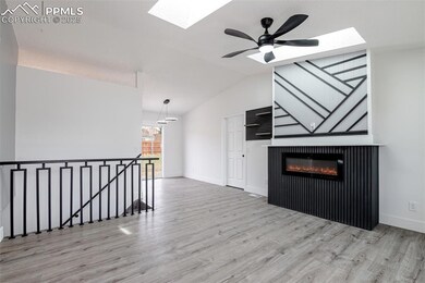 Unfurnished living room with baseboards, vaulted c