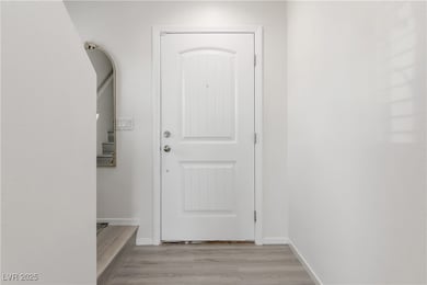 Doorway featuring light wood-type flooring and bas