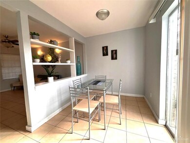 Dining area featuring built in shelves, baseboards, and light tile patterned floors