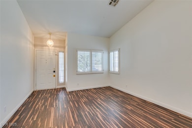 Entryway featuring dark wood-type flooring, basebo