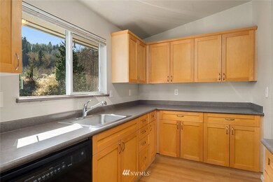 Enjoy the spacious kitchen with beautiful floors and cabinetry.