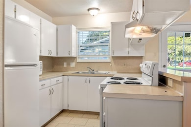 Kitchen with freestanding refrigerator, light cou
