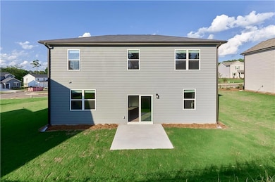 Back of property featuring a lawn and a patio area