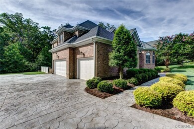 Three-car garage, stamped concrete driveway and si
