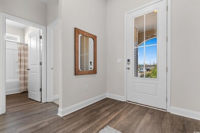 Entryway with dark wood-style flooring and baseboards