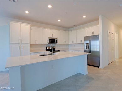 Kitchen with stainless steel appliances, white cab