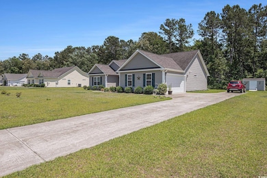 Ranch-style home with concrete driveway, an attached garage, a front lawn, and a shingled roof