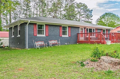 Rear view of house featuring brick siding, a woode