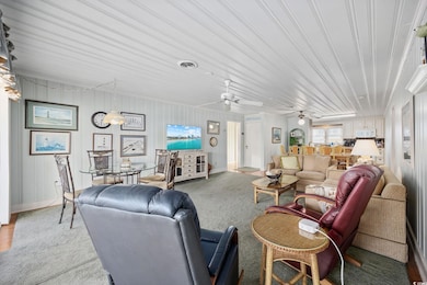 Living area with visible vents and ceiling fan