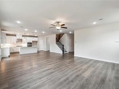 Unfurnished living room with stairway, recessed lighting, ceiling fan, and wood finished floors