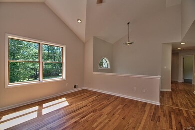 The living room feature solid hardwood floors, a l